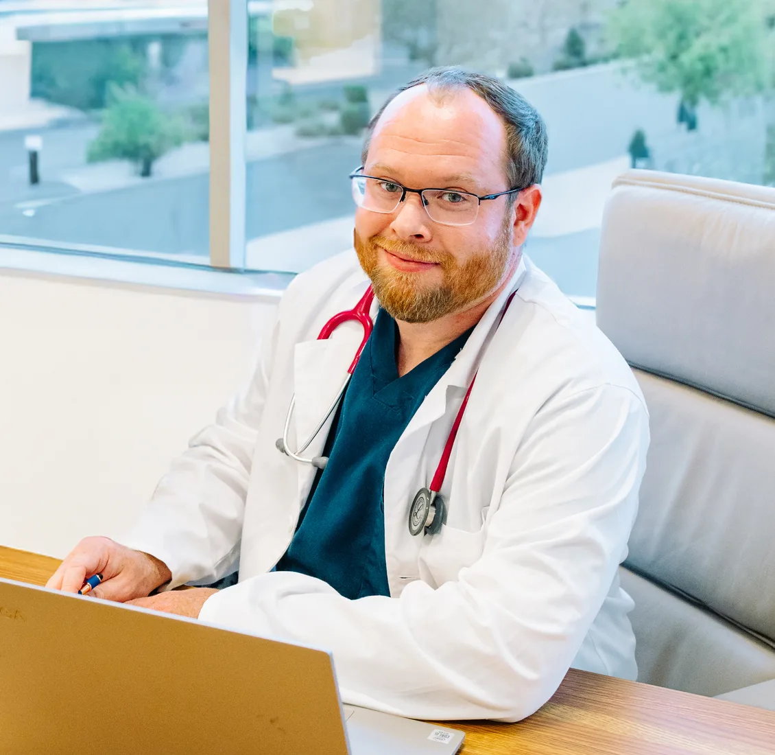 Dr. Ben Stills, smiling, in a white coat with a stethoscope
