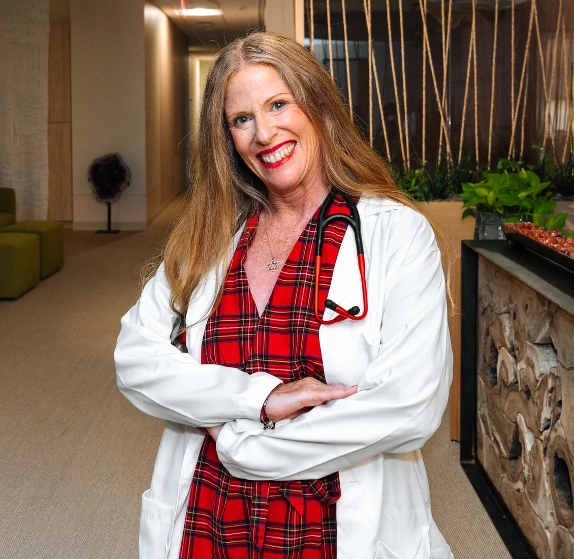 Dr. Sharon Stills, smiling, in a white coat with a stethoscope